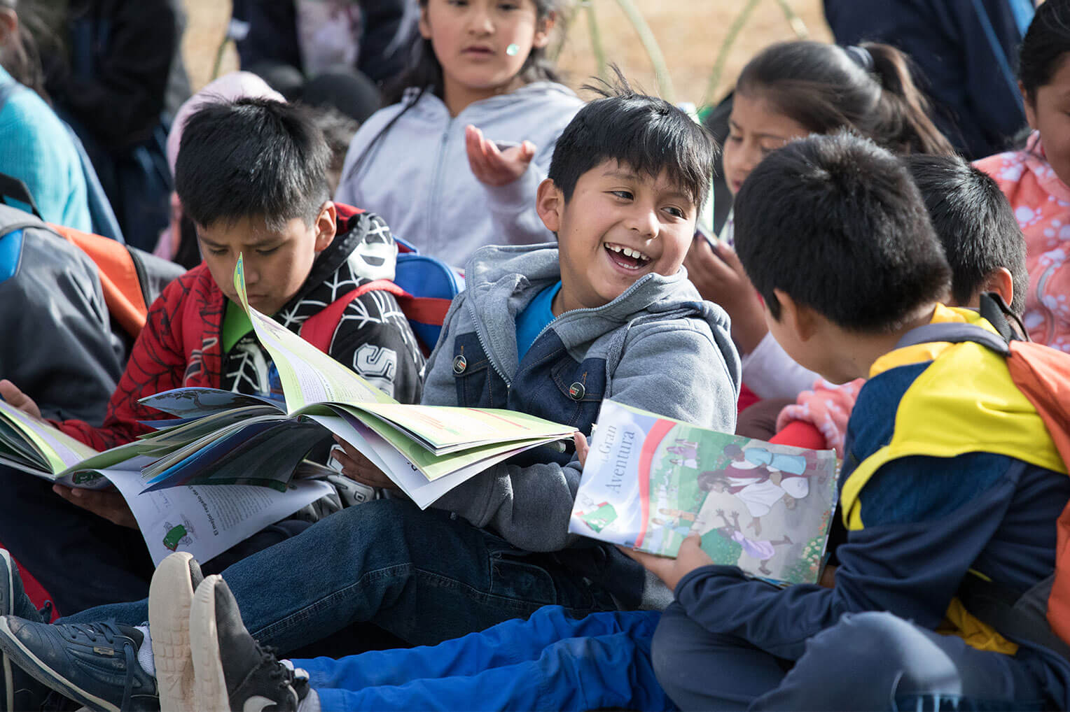 Boys and girls reading The Greatest Journey booklet